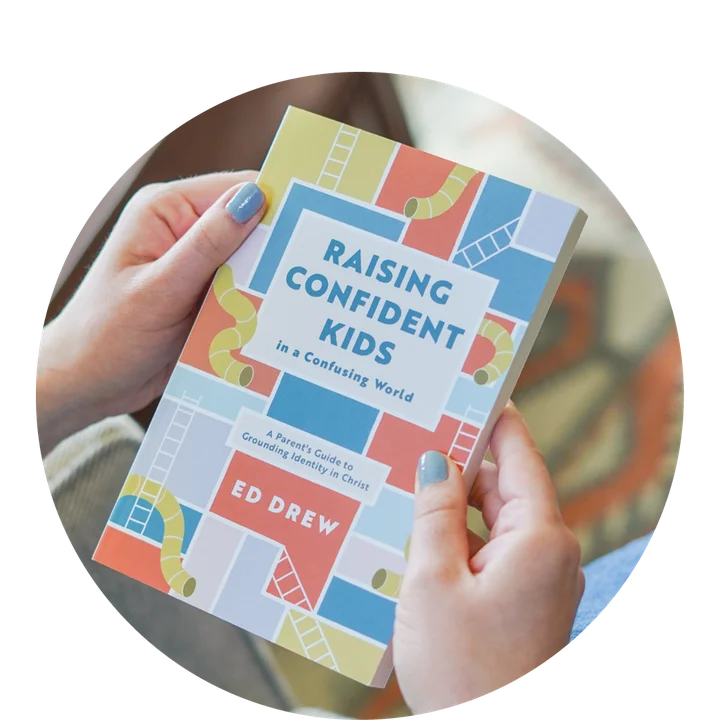 photograph of a person holding Raising Confident Kids in a Confusing World