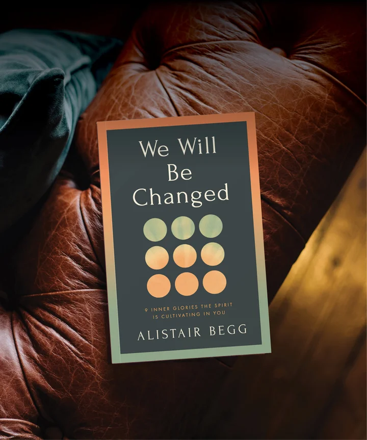 We Will Be Changed by Alistair Begg on a leather chair arm