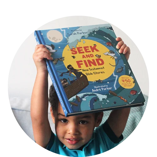 little boy holding up Seek and Find: New Testament